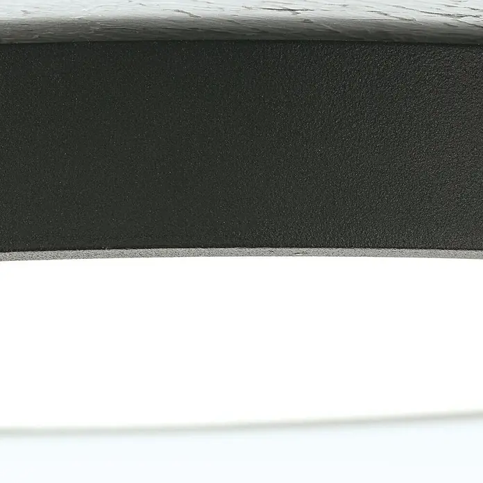 Orion Leuchten LED-Panel rund -  - Nahaufnahme einer dunkelgrauen Oberfläche mit grober, körniger Textur.