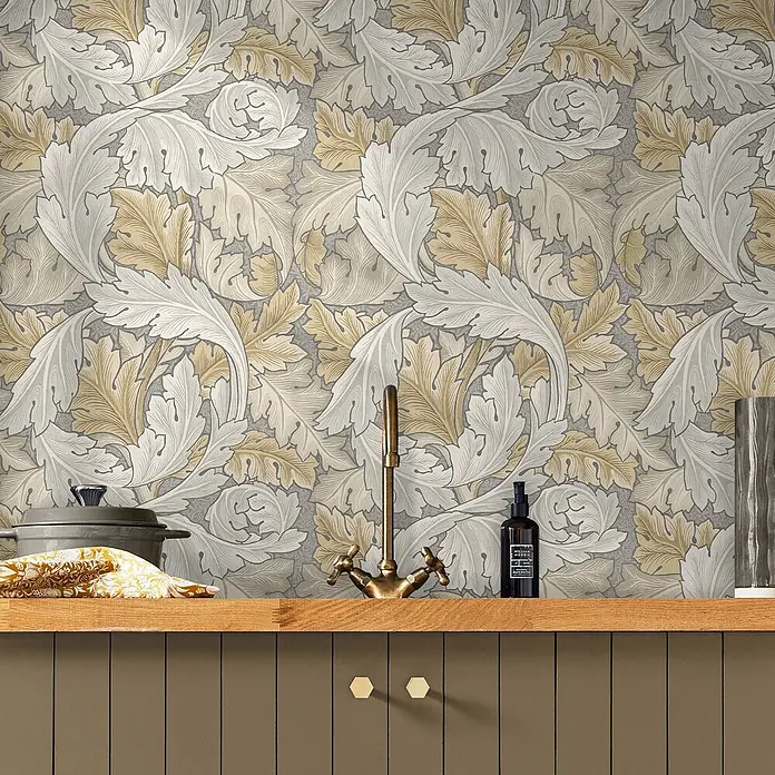 William Morris At Home Vliestapete Vliestapete Akanthus - Beige, Streifen, 10 x 0,52 m - Tapete mit großflächigem Akanthusblattmuster in Hellgrau und Goldbeige, in einer Küche abgebildet.