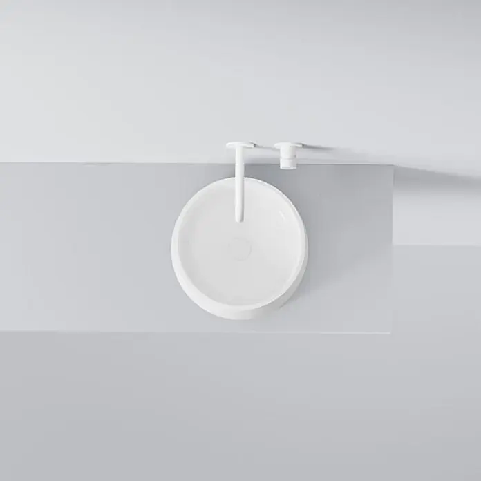 Vola Waschtisch - 0 x 0 cm - Weißes rundes Aufsatzwaschbecken mit passender weißer Wandarmatur und Drehknopf, von oben gesehen.
