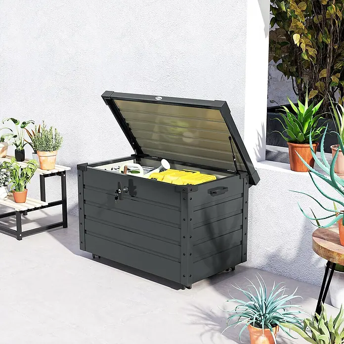 Furnicato Garten-Aufbewahrungsbox - Dunkelgrau, Stahl - Dunkelgraue Outdoor-Aufbewahrungsbox mit offenem Deckel, Gartengeräte enthaltend, auf einer Terrasse neben Pflanzen. Mit Rollen und Schloss.