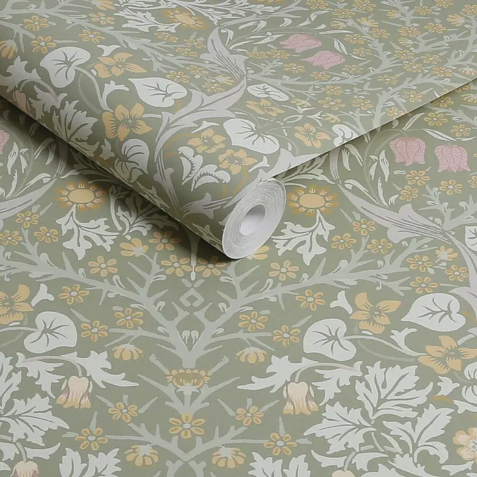William Morris At Home Vliestapete Vliestapete Schlehdorn - Salbeigrün, Floral, 10 x 0,52 m - Salbeigrüntapete mit creme, gelben und rosa Blumenmuster, teilweise abgerollt, um das Design zu zeigen.