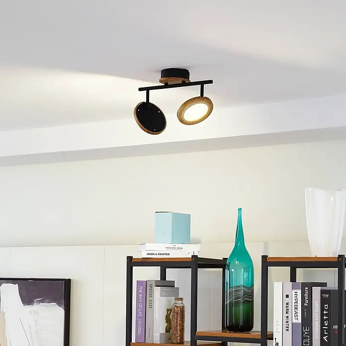 Lindby Deckenstrahler Manel - L x B x H: 37 x 13 x 22 cm, Holz hell, Holz hell - Schwarze und holzfarbene Deckenleuchte mit zwei Strahlern, an der Decke montiert. Ein Strahler leuchtet und zeigt die Lichtausbeute.