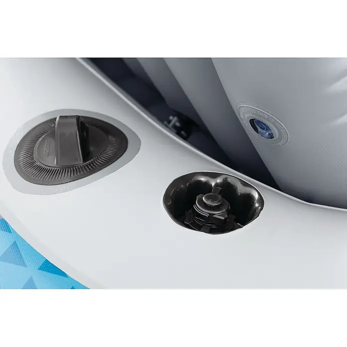 Intex Schlauchboot-Set Excursion 5 - Geeignet für: Max. 5 Personen, L x B x H: 366 x 168 x 43 cm - Nahaufnahme von zwei schwarzen Aufblasventilen auf einem weißen Schlauchboot oder Poolschwimmer, darunter ein Boston-Ventil mit Intex-Kappe.
