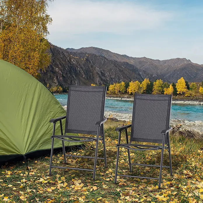Outsunny Gartenstuhl-Set - 2 Stk., 70%PVC/30%Polyester, Klappbar, Schwarz - Zwei schwarze klappbare Outdoor-Stühle mit dunklen Gestellen stehen neben einem grünen Zelt an einem Fluss in einer herbstlichen Berglandschaft.