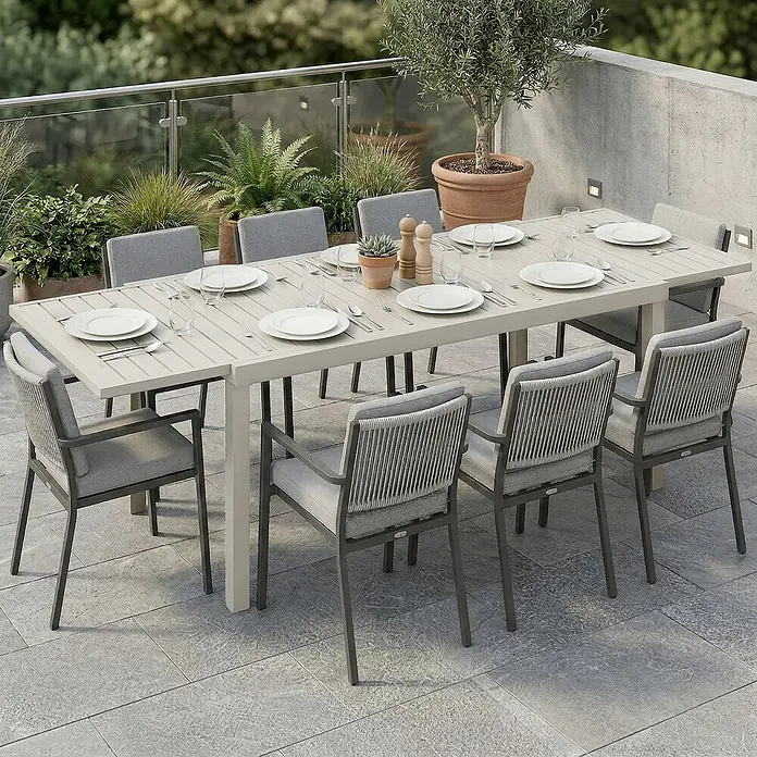 Outsunny Gartentisch - L x B x H: 225 x 85 x 75 cm, Aluminium, Weiß - Outdoor-Essgruppe mit hellem Lamellentisch und acht Stühlen mit dunklen Gestellen, hellgrauen Kissen und Seil-Rückenlehnen auf einer Terrasse.