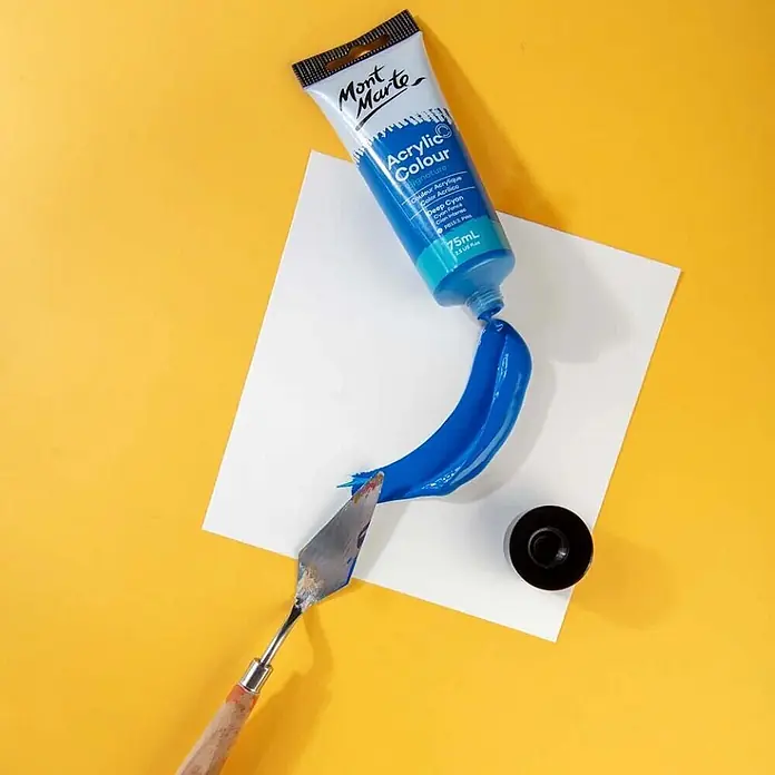 Mont Marte Acrylfarbe Signature - Dunkles Cyanblau, 75 ml, Tube - Tube Mont Marte Tiefblau Acrylfarbe auf weißes Papier gedrückt, daneben ein Spachtel.