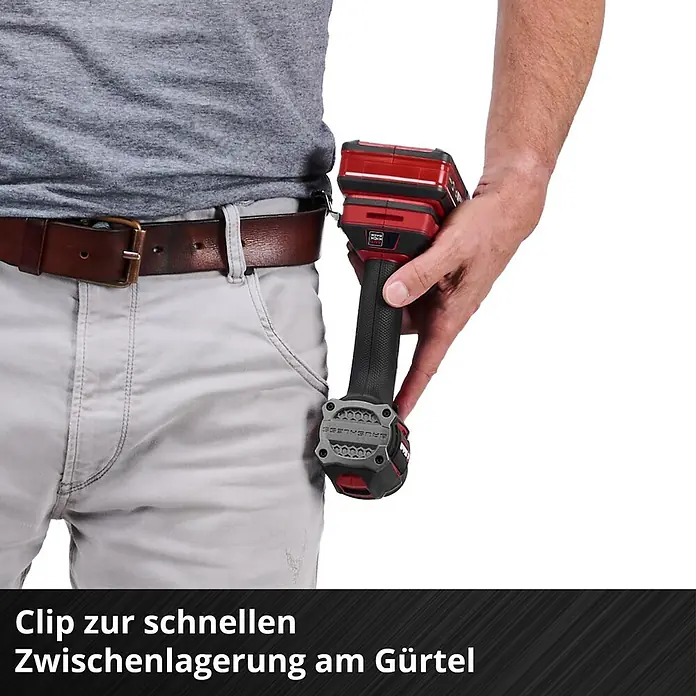 Einhell Professional Power X-Change 18V Akku-Schlagbohrschrauber TP-CD 18/50-C Li-i BL - Solo - 18 V, Ohne Akku, 50 Nm - Rot-schwarzes Akkuwerkzeug mit Gürtelclip, an einem braunen Gürtel an hellgrauer Hose zur einfachen Aufbewahrung befestigt.