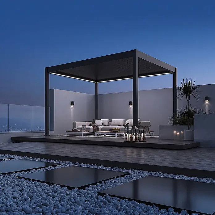 Weide Pergola Deluxe freistehend 3,6 x 4 m Anthrazit Aluminium - Farbe Gestell: Sandpapier FinishAnthrazit / RAL Farbcode 7024, Aluminium - Moderne schwarze Pergola mit integrierter LED-Beleuchtung über einem Sitzbereich auf einer Dachterrasse.