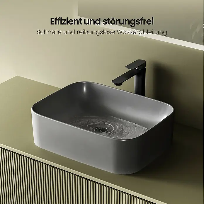 Emke Aufsatzwaschbecken CB09 - 605 x 380 mm, Hahnloch: Ohne, Ohne Überlauf, Dunkelgrau matt - Dunkelgraues rechteckiges Aufsatzwaschbecken mit schwarzem Wasserhahn, das effizientes Abfließen des Wassers zeigt.
