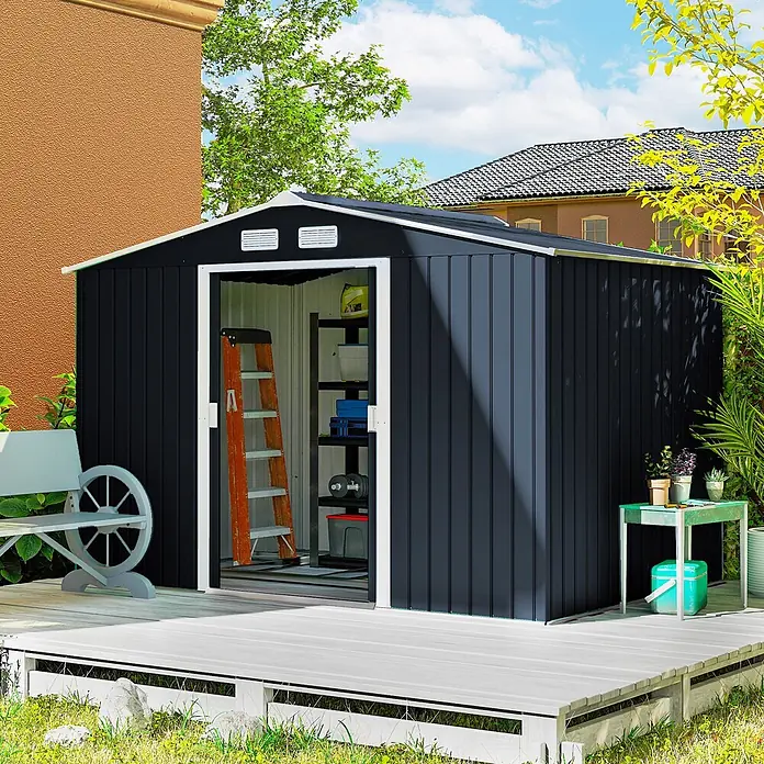 Outsunny Gerätehaus - Außenbreite inkl. Dachüberstand: 277 cm, Außentiefe inkl. Dachüberstand: 195 cm, Stahl, Dunkelgrau - Dunkelgraues Metall-Gartenhaus mit weißem Rahmen, offene Tür zeigt Stauraum, auf heller Holzterrasse im Garten.