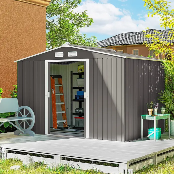 Outsunny Gerätehaus - Außenbreite inkl. Dachüberstand: 277 cm, Außentiefe inkl. Dachüberstand: 195 cm, Stahl, Grau - Dunkelgraues Metallgartenhaus mit weißer Zierleiste auf einer hellgrauen Terrasse im Garten.