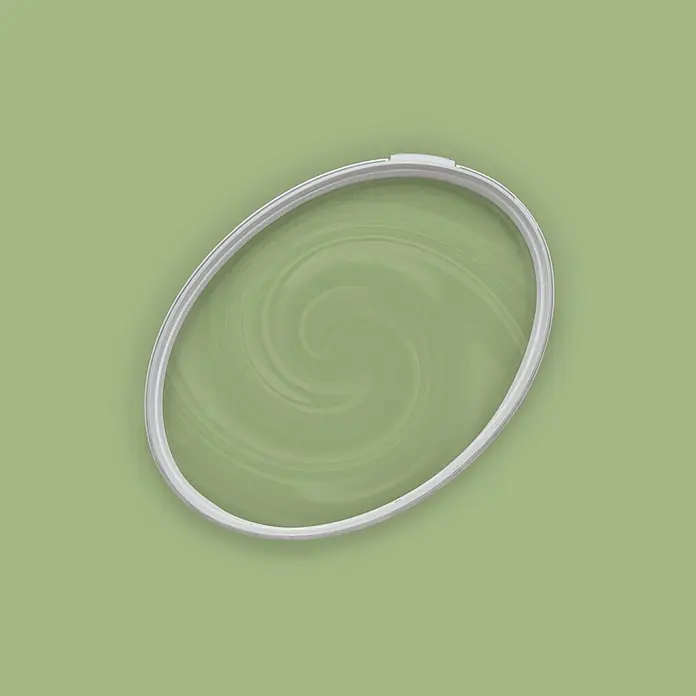 Tadessi Wandfarbe Frühling Sage Green - Grün, Matt, 5 l - Weißer ovaler Stickrahmen, der grünen Stoff mit einem subtilen Wirbelmuster spannt.