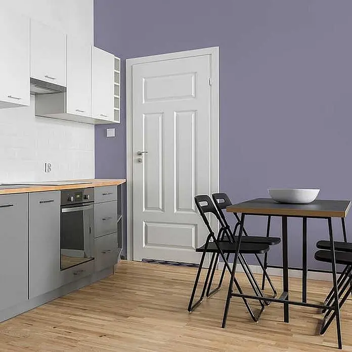 Tadessi Wandfarbe Blasslavendel - Violett, Matt, 1 l - Schwarzer Esstisch mit vier schwarzen Klappstühlen in einer modernen Küche. Tischplatte in Holzoptik.