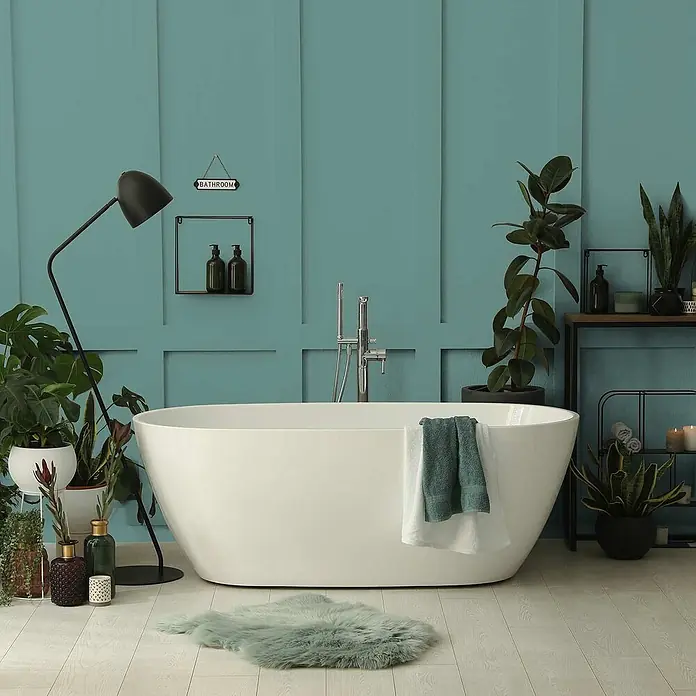 Tadessi Wandfarbe Blattgrün - Grün, Matt, 2,5 l - Weiße freistehende Badewanne in einem modernen Badezimmer mit teal Wänden und Pflanzen.