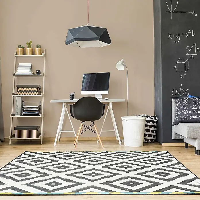 Tadessi Wandfarbe Leinenbeige - Beige, Matt, 1 l - Eine schwarz-weiße geometrische Deckenlampe hängt über einem modernen Schreibtisch in einem Arbeitszimmer.