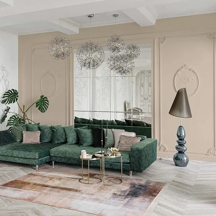 Tadessi Wandfarbe Cremebeige - Beige, Matt, 5 l - Ein großes, tiefgrünes Ecksofa, das viel Platz in einem modernen Wohnzimmer bietet.