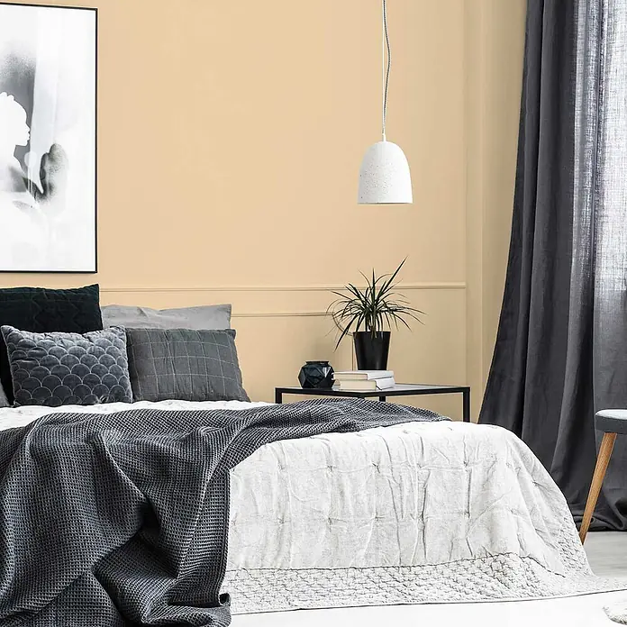 Tadessi Wandfarbe Graubeige - Beige, Matt, 5 l - Grauer Waffelstricküberwurf und weiße gesteppte Tagesdecke auf einem Bett, ergänzt durch graue Kissen in einem gemütlichen Schlafzimmer.