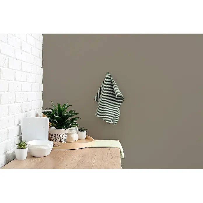 Tadessi Wandfarbe Treibholz Mocha - Taupe, Matt, 2,5 l - Grün gestreiftes Küchentuch und passende Matte auf einer Holztheke mit Pflanzen, weißen Schüsseln und einem Glasgefäß.