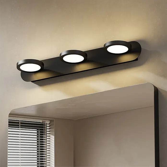 Emke LED-Spiegelleuchte L24 - 15 W, Schwarz - Schwarze Spiegelleuchte mit drei runden Lichtern über einem Spiegel montiert, beleuchtet die Wand.