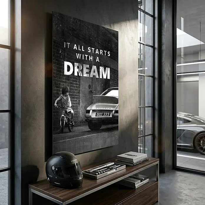 Dotcomcanvas Decopanel - It All Starts with a Dream, B x H: 58 x 90 cm - Schwarz-weißes Leinwandbild mit Kind auf Rad, Porsche und dem Text 'IT ALL STARTS WITH A DREAM', in modernem Raum.
