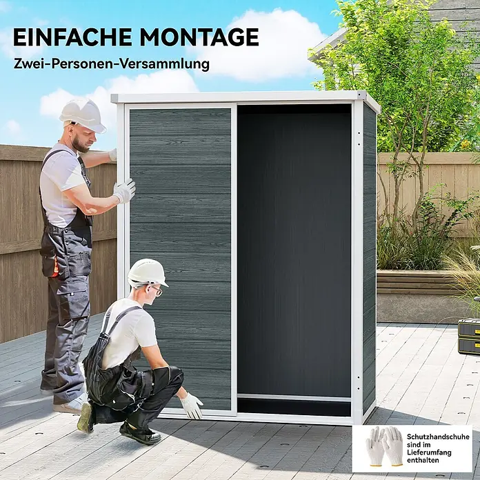Outsunny Gerätehaus - Außenbreite inkl. Dachüberstand: 134 cm, Außentiefe inkl. Dachüberstand: 68,5 cm, Aluminium, Grau - Zwei Personen montieren einen dunkelgrauen Garten-Abstellschrank mit Schiebetüren auf einer Holzterrasse.