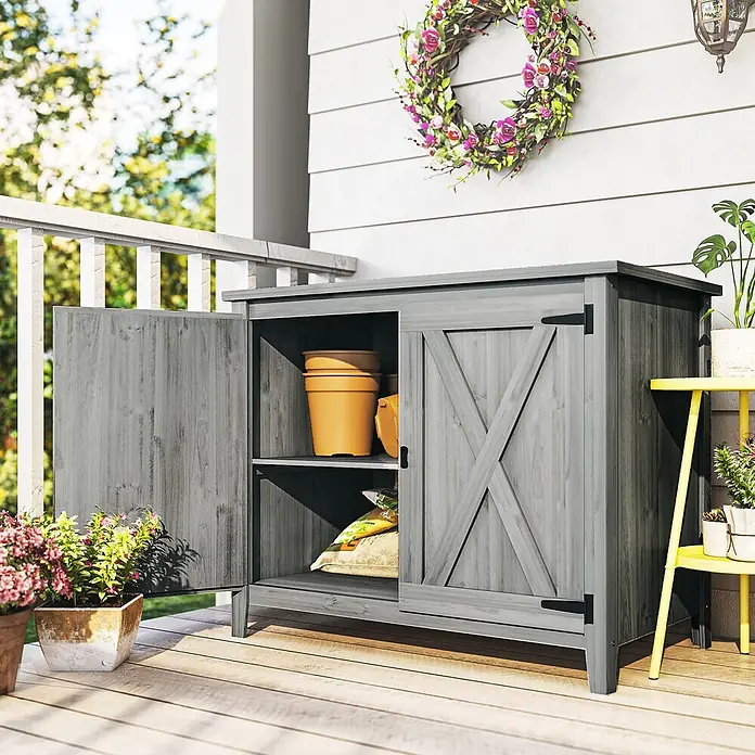Outsunny Geräteschrank - Außenbreite inkl. Dachüberstand: 110 cm, Außentiefe inkl. Dachüberstand: 60 cm, Holz, Hellgrau - Grauer Holz-Gartenschrank mit einer geöffneten Tür, die Gartentöpfe und eine Tasche zeigt, auf einer Veranda platziert.