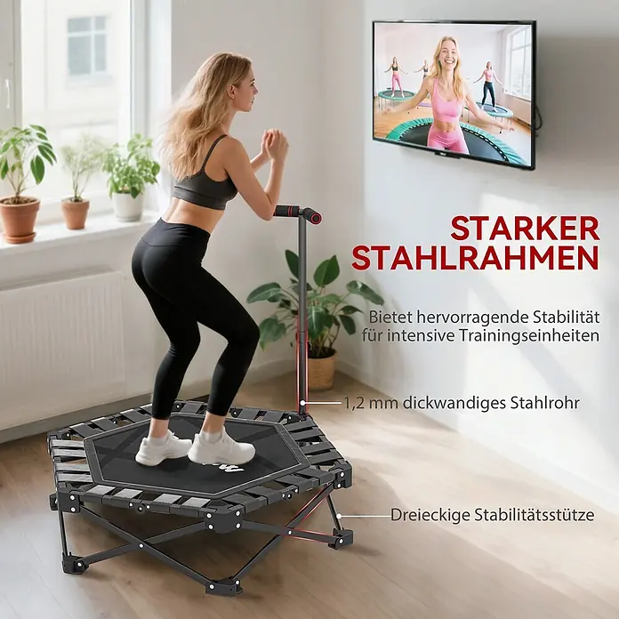 Sportnow Rebounder - Stahl, Schwarz - Frau trainiert auf schwarzem Fitness-Trampolin mit starkem Stahlrahmen und rotem Griff. Ein Fernseher zeigt Personen auf ähnlichen Trampolinen.
