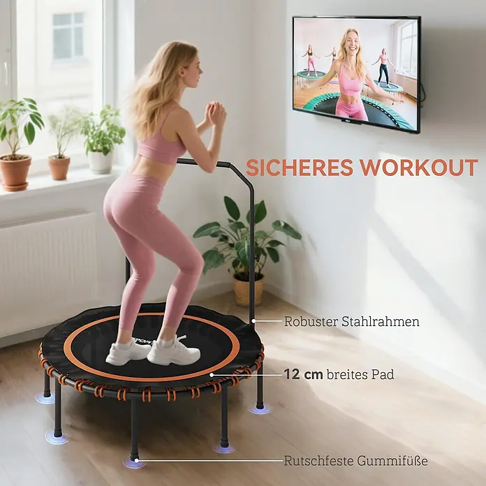 Sportnow Rebounder - Stahl, Schwarz, Orange - Frau springt auf einem schwarz-orangefarbenen Mini-Trampolin mit Griff. Merkmale: robuster Stahlrahmen, 12 cm breites Polster und rutschfeste Füße.