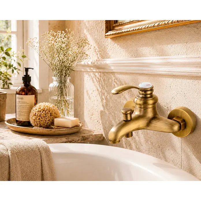 Rousseau Grifo monomando de bañera Byron - Bronce - Grifo de bañera de latón montado en la pared con monomando y desviador, integrado en un ambiente de baño de tonos naturales.