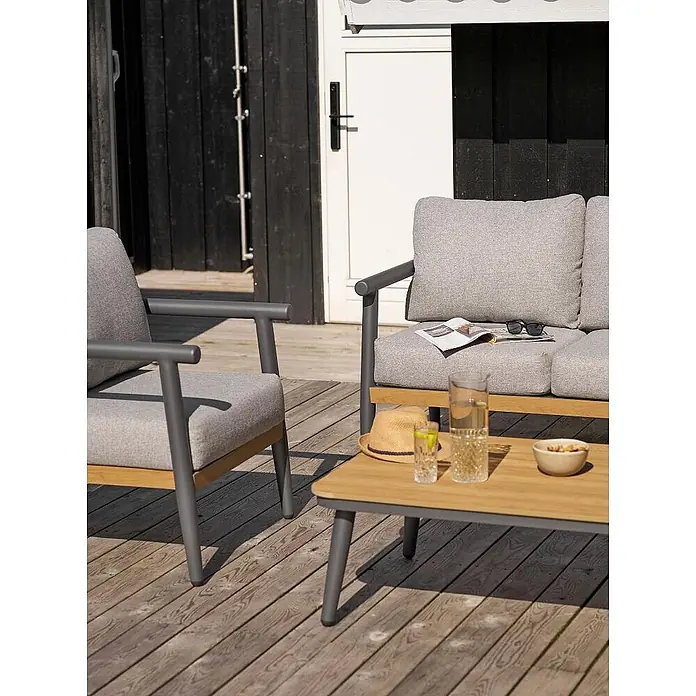 Ebuy24 Loungemöbel-Set Camilla - 4 -tlg., Nonwood (PE), Aluminium, Polyester, Graubeige - Graue Outdoor-Lounge-Garnitur mit Holzdetails, bestehend aus Sessel, Sofa und Couchtisch auf Holzterrasse.