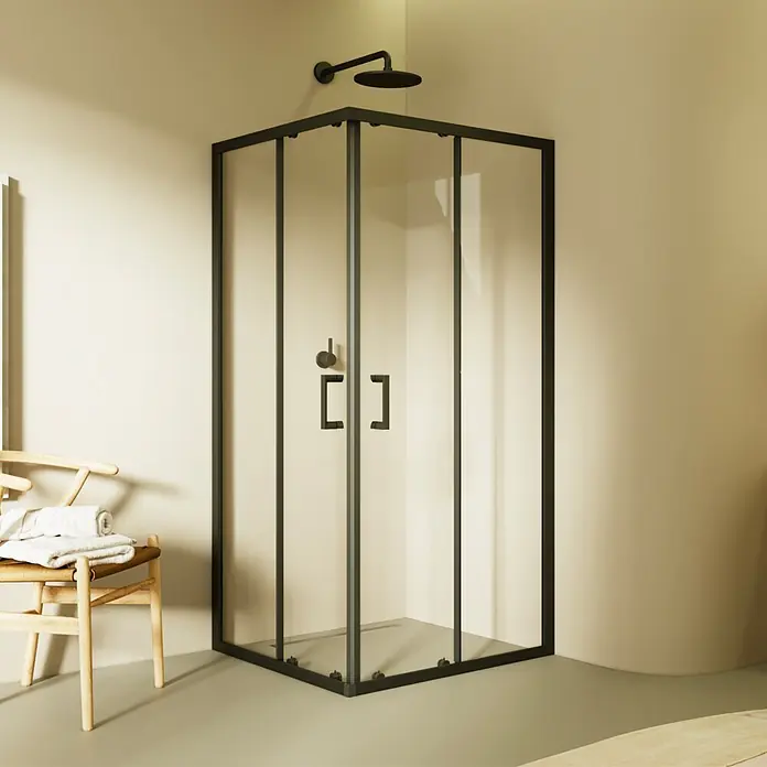 i-flair Eckdusche DK79C80x80 - Beschichtet, Schwarz, Stärke: 6 mm - Schwarz gerahmte Glasduschkabine mit Duschkopf, in hellem Bad neben Holzstuhl mit Handtüchern.