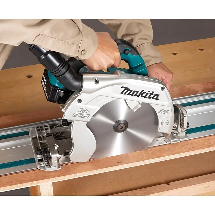 Makita LXT 18V Akku-Handkreissäge DHS900ZU - 36 V, Ohne Akku, Durchmesser Sägeblatt: 235 mm - Makita Akku-Tauchsäge, silber-türkis, schneidet Holz auf einer Führungsschiene, bedient von Händen.
