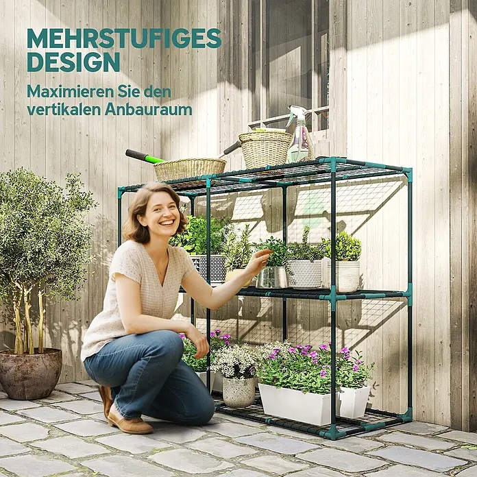 Outsunny Gewächshaus-Regal - 143 x 48 x 100 cm, Dunkelgrün - Eine Frau pflegt Pflanzen auf einem dunkelgrünen, mehrstufigen Metall-Pflanzregal, das vertikalen Gartenraum maximiert.