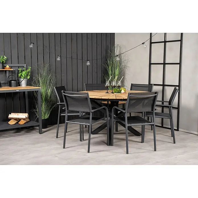 Ebuy24 Gartentisch rund New Mexico - Ø x H: 140 x 75 cm, Aluminium, Teak, Schwarz, Stapelbar - Outdoor-Essgruppe: ein runder Holztisch mit dunkelgrauen Netzstühlen, auf einer modernen Terrasse arrangiert.