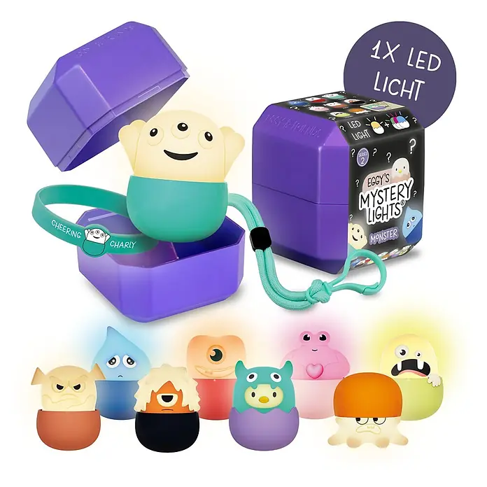 MegaLight LED-Nachtlicht Mystery Lights Eggys Monster - 0,2 W, L x B x H: 70 x 65 x 65 mm, RGBW, 1 Stk. - Lila Überraschungsbox mit einem leuchtenden Monster-LED-Licht und tealfarbenem Band; daneben geschlossene Box und weitere leuchtende Monsterfiguren.