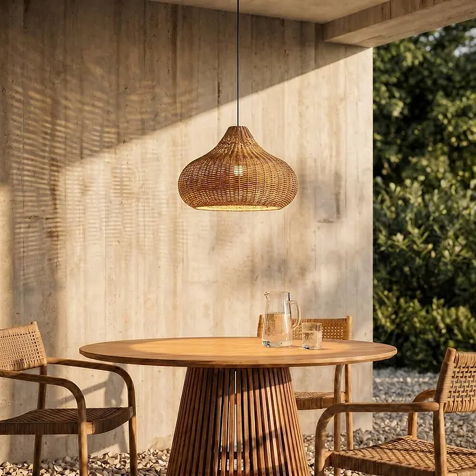 Lucande Außenwand- & Deckenleuchte Taniola - Holz hell, IP44 - Geflochtene Rattan-Pendelleuchte in Naturfarben, hängt über einem hölzernen Outdoor-Esstisch mit Stühlen.