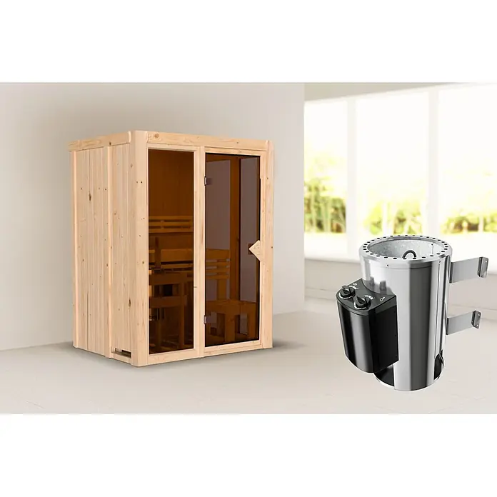 Karibu Elementsauna Balder - L x B x H: 122 x 155 x 198 cm, Plug & Play 3,6 KW Ofen mit interner Steuerung - Hölzerne Saunakabine mit Glastüren und einem silber-schwarzen elektrischen Saunaofen in einem hellen Raum.