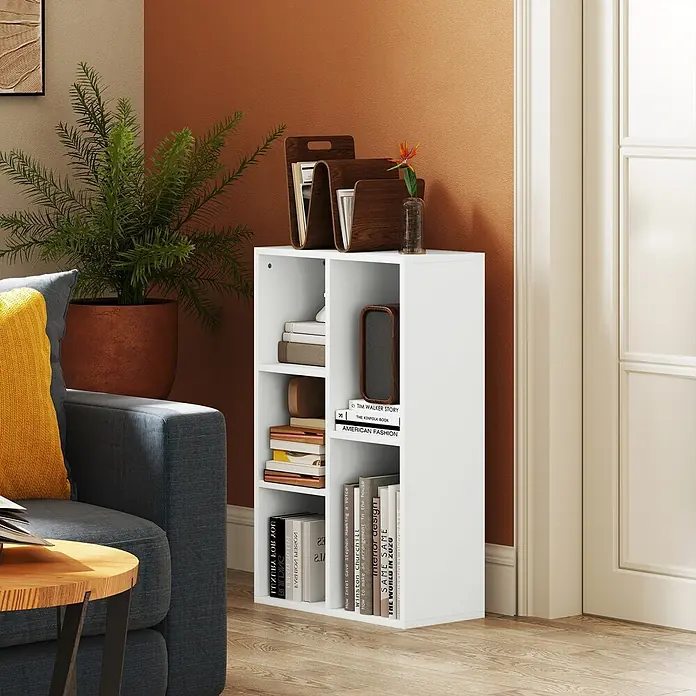 Homcom Holzregal - H x B x T: 80 x 24 x 24 cm, Traglast pro Boden: 8 kg, Anzahl Böden: 5 Stk., Schrauben, Weiß - Kompaktes weißes Holzregal mit mehreren Fächern, gefüllt mit Büchern und Deko, neben einem grauen Sofa und einer Topfpflanze.