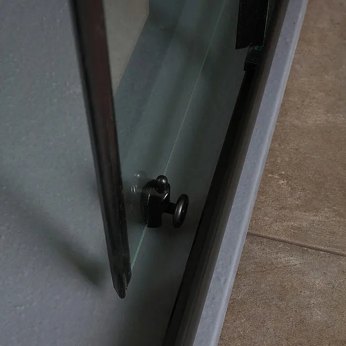 Kiamami Valentina Eckdusche - 900 x 700 x 1.900 cm, Schwarz, Weiß, Stärke: 6 mm - Nahaufnahme eines schwarzen unteren Führungsrads an einer Duschkabinentür aus Glas.
