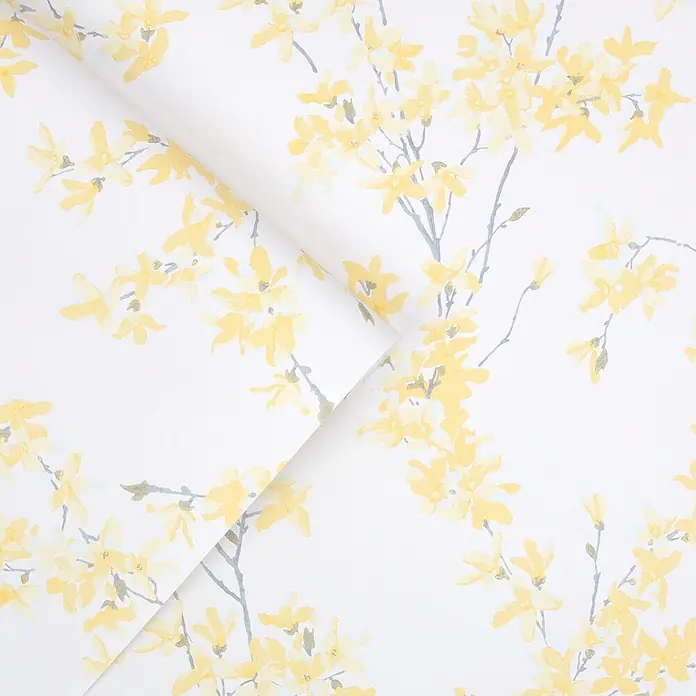 Laura Ashley Vliestapete Forstyhia Blumen - Gelb, Floral, 1.000 x 52 cm - Weiße Tapete mit gelbem Blumenmuster und grauen Zweigen, teilweise aufgerollt.
