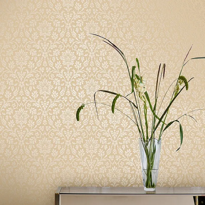 Laura Ashley Vliestapete Annecy Linen - Beige, Floral, 1.000 x 52 cm - Beigefarbene Tapete mit elegantem weißem Damastmuster an einer Wand.