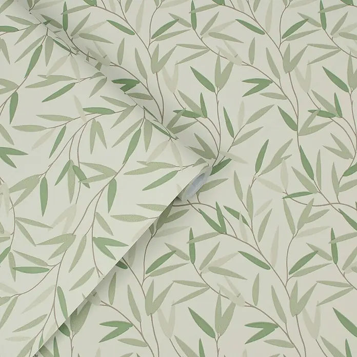 Laura Ashley Vliestapete Weidenblatt - Grün, Floral, 1.000 x 52 cm - Tapetenrolle mit Muster aus grünen Blättern und braunen Ästen auf hellem Grund, teilweise abgerollt.