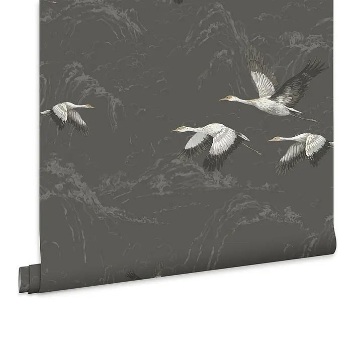 Laura Ashley Vliestapete Animalia - Grau, Tieroptik, 1.000 x 52 cm - Dunkelgraue Tapetenrolle mit einem Muster aus weißen Kranichen, die über Berge fliegen.