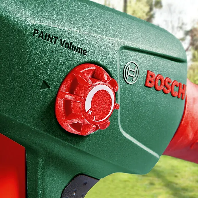 Bosch Sistema de pulverización de pintura PFS 1000 - Apto para: Esmaltes, Absorción nominal de corriente: 410 W, 800 ml - Primer plano de un pulverizador de pintura verde de Bosch con un regulador de volumen de pintura rojo y el logo de la empresa.