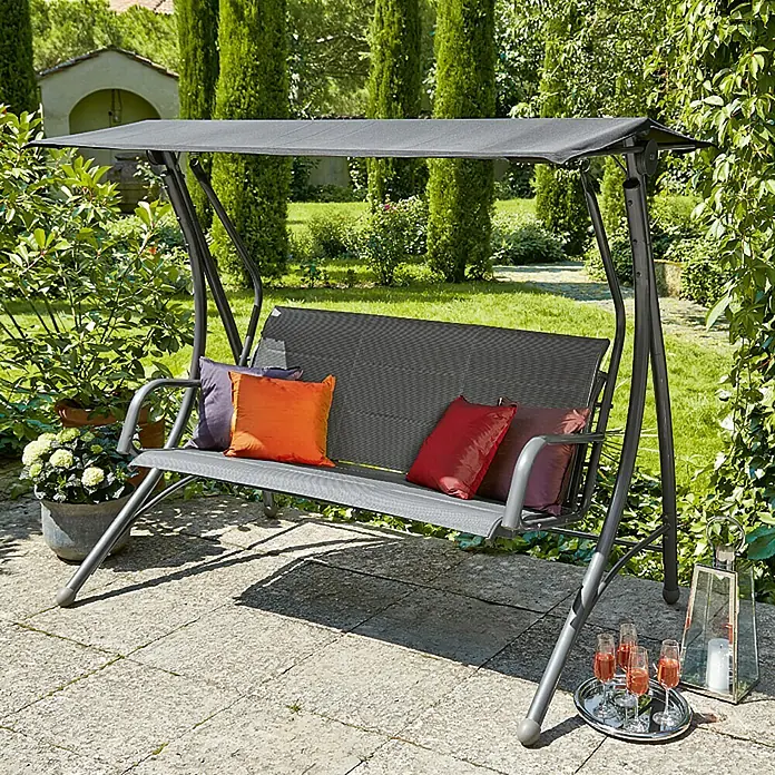 Sunfun Maja Hollywoodschaukel Padded - L x B x H: 186 x 123 x 167 cm, Stahl, Anthrazit - Gartenmöbel: Eine graue Hollywoodschaukel mit Kissen auf einer Terrasse, ideal zum Entspannen im Freien.