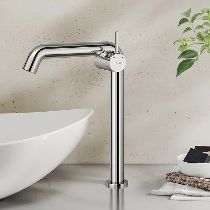 Emke Waschtischarmatur Flowcurv XF24 - Chrom, Glänzend - Hoher, glänzender Chromwasserhahn mit Einhebelmischer und rot/blau-Markierungen, neben einem weißen Waschbecken.