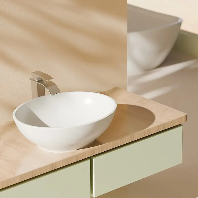 Emke Aufsatzwaschbecken Bovelari CB05 - 33,5 x 41,5 cm, Hahnloch: Ohne, Ohne Überlauf, Weiß - Moderner Badezimmerschrank mit weißem Aufsatzwaschbecken, silbernem Wasserhahn, heller Holzplatte und hellgrünen Schubladen, in natürlichem Licht.