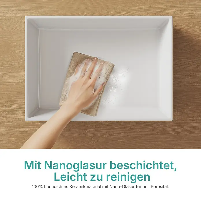 Emke Aufsatzwaschbecken Ceraedge CB28 - 37,3 x 51 cm, Hahnloch: Ohne, Ohne Überlauf, Weiß - Weißes Keramikwaschbecken mit Nanoglasur wird von einer Hand mit einem Seiftuch gereinigt.