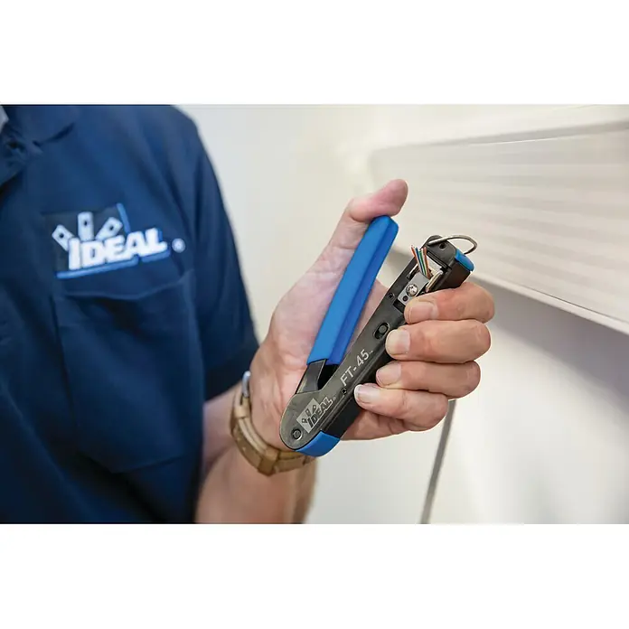 Ideal Crimpzange für Modular-Stecker FT-45 - Länge: 27,94 cm, Blau - Person benutzt ein schwarz-blaues Ideal FT-45 Crimpzangenwerkzeug zum Vorbereiten eines Ethernet-Kabels.