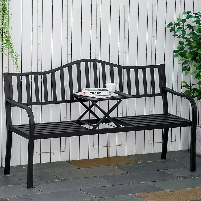 Outsunny Gartenbank - B x T x H: 58,5 x 58,5 x 90 cm, Metall, Schwarz, Ausziehbar - Schwarze Gartenbank aus Metall mit integriertem Klapptisch, auf dem eine Zeitschrift und Tasse stehen, auf einer Terrasse.